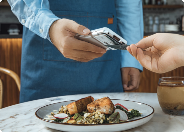 Image showing someone paying using the portable payment terminal
